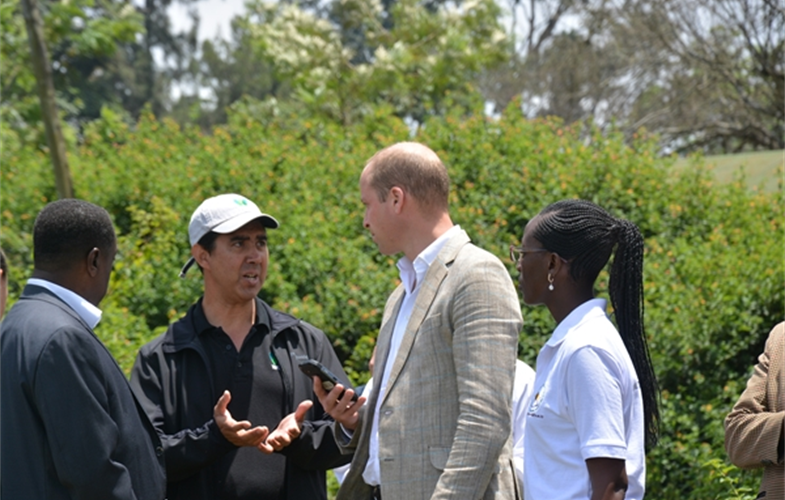 Dr. Tony Lynam (left), the Duke of Cambridge (center), and CAWM Instructor Elizabeth Kamili discuss how to record an observation with the Cybertracker-equipped smartphone. CREDIT: College of African Wildlife Management-Mweka